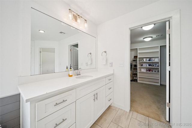 7383 S 288th E Ave, Broken Arrow, OK 74014 - bathroom featuring vanity, a spacious closet, and tile patterned flooring