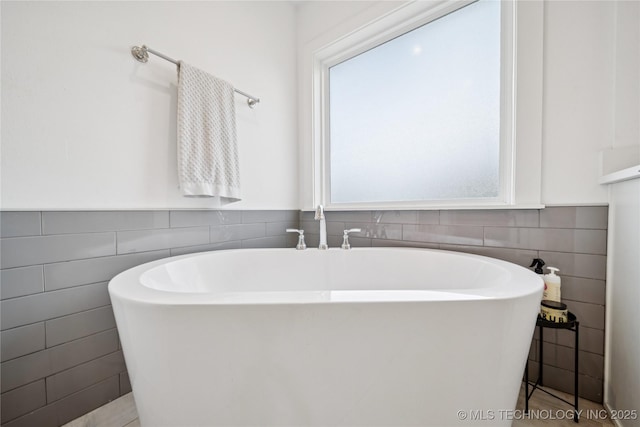 7383 S 288th E Ave, Broken Arrow, OK 74014 - bathroom featuring tile walls and a soaking tub