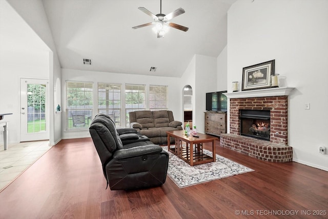 7316 E Knoxville St, Broken Arrow, OK 74014 - living room featuring high vaulted ceiling, a fireplace, ceiling fan, and wood finished floors