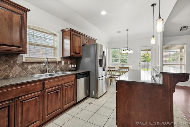 7316 E Knoxville St, Broken Arrow, OK 74014 - kitchen featuring a breakfast bar area, a chandelier, decorative backsplash, dishwasher, and decorative light fixtures