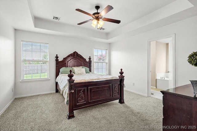 7316 E Knoxville St, Broken Arrow, OK 74014 - bedroom with a tray ceiling, light colored carpet, connected bathroom, and ceiling fan
