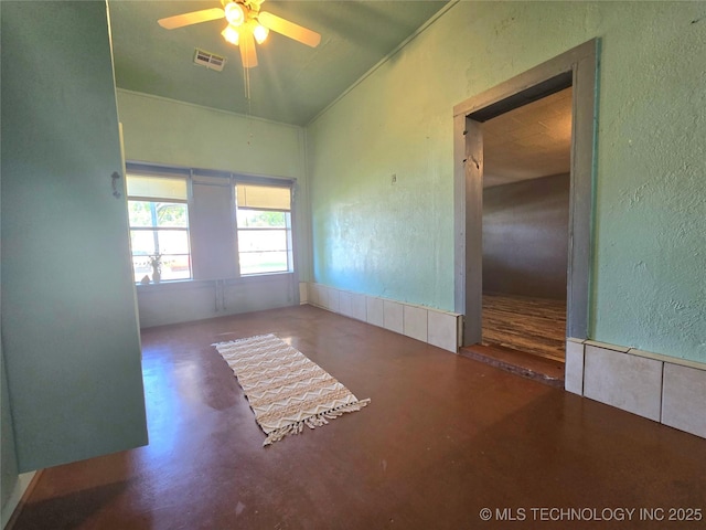 305 Chronister Ave, Drumright, OK 74030 - spare room with concrete flooring, a ceiling fan, and a textured wall