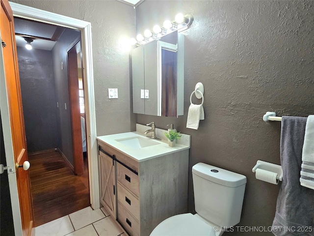 305 Chronister Ave, Drumright, OK 74030 - half bath with vanity, a textured wall, and tile patterned floors