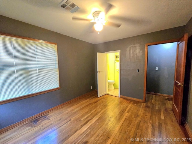 305 Chronister Ave, Drumright, OK 74030 - unfurnished bedroom with wood finished floors, ensuite bathroom, and ceiling fan