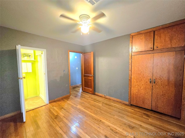 305 Chronister Ave, Drumright, OK 74030 - unfurnished bedroom featuring light wood-style floors, a closet, and a ceiling fan