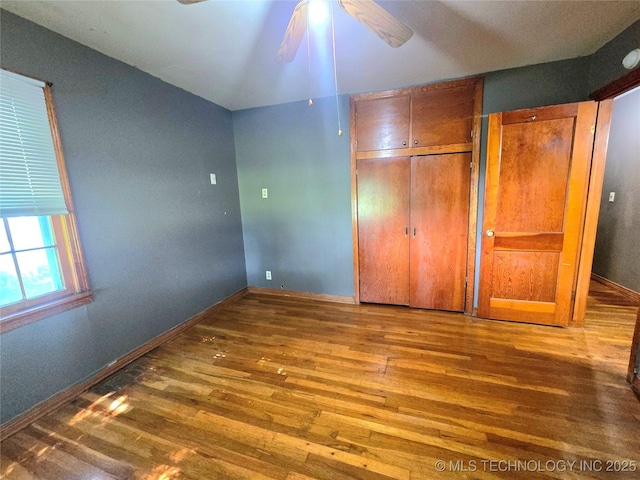 305 Chronister Ave, Drumright, OK 74030 - unfurnished bedroom featuring wood finished floors, a closet, and a ceiling fan