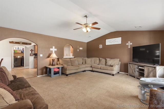 24 Faye Ave, Inola, OK 74036 - living area with ceiling fan, lofted ceiling, light carpet, arched walkways, and washing machine and dryer
