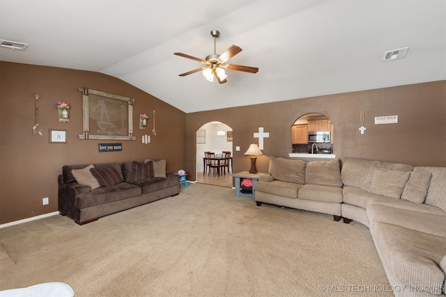 24 Faye Ave, Inola, OK 74036 - living room featuring arched walkways, lofted ceiling, a ceiling fan, and carpet floors