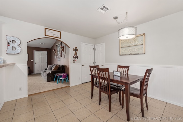 24 Faye Ave, Inola, OK 74036 - dining area with arched walkways, wainscoting, and light tile patterned flooring