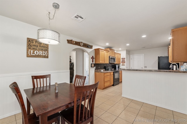 24 Faye Ave, Inola, OK 74036 - dining area with light tile patterned flooring, arched walkways, and recessed lighting