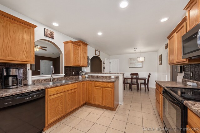 24 Faye Ave, Inola, OK 74036 - kitchen with black appliances, decorative backsplash, arched walkways, light tile patterned flooring, and recessed lighting