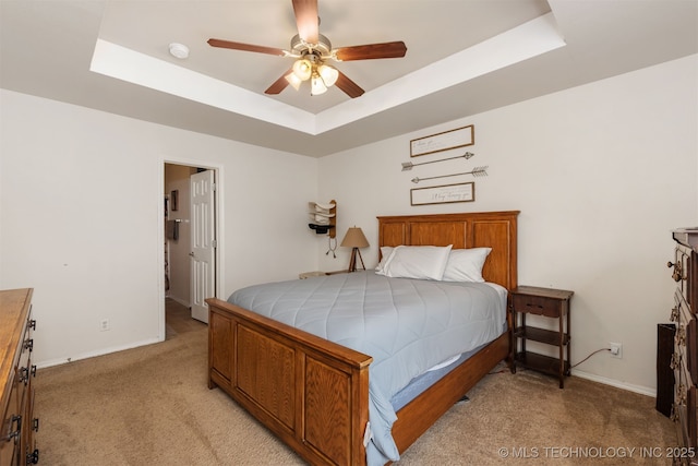 24 Faye Ave, Inola, OK 74036 - bedroom with light colored carpet, a raised ceiling, and a ceiling fan