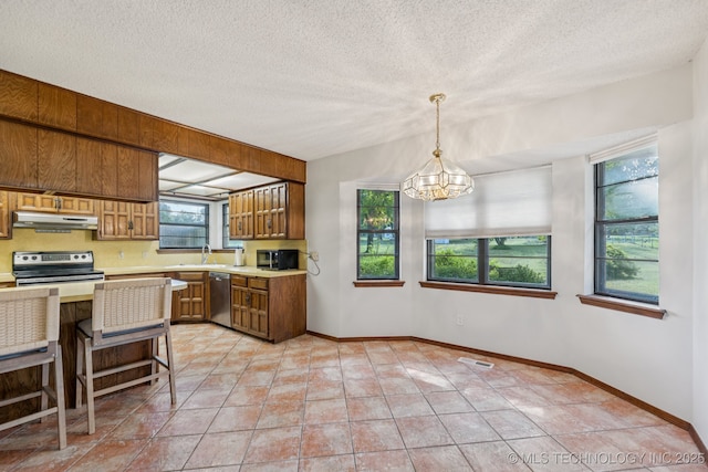 10421 S 197th E Ave, Broken Arrow, OK 74014 - kitchen featuring light countertops, brown cabinets, appliances with stainless steel finishes, a chandelier, and hanging light fixtures