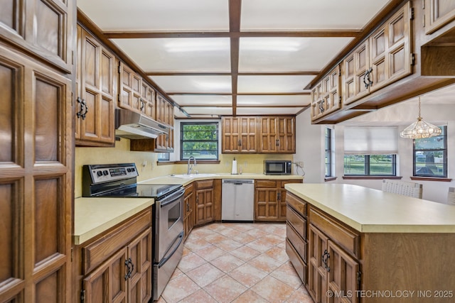 10421 S 197th E Ave, Broken Arrow, OK 74014 - kitchen featuring stainless steel appliances, brown cabinets, light countertops, under cabinet range hood, and a chandelier
