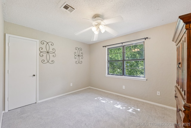 10421 S 197th E Ave, Broken Arrow, OK 74014 - unfurnished bedroom featuring carpet floors, a textured ceiling, and a ceiling fan
