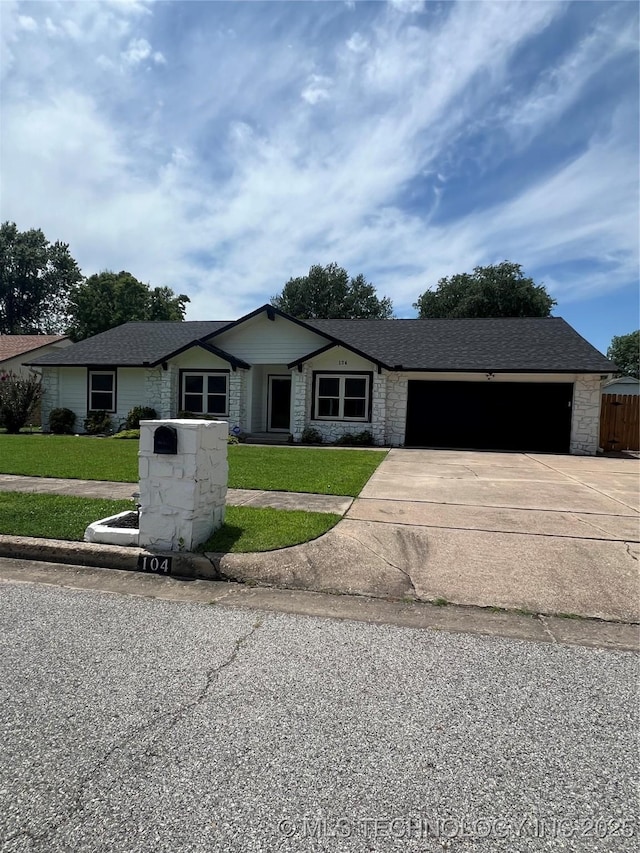 104 S Joshua Ave E, Broken Arrow, OK 74012 - ranch-style house with stone siding, driveway, an attached garage, roof with shingles, and a front lawn