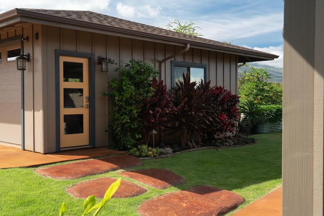 doorway to property with a yard