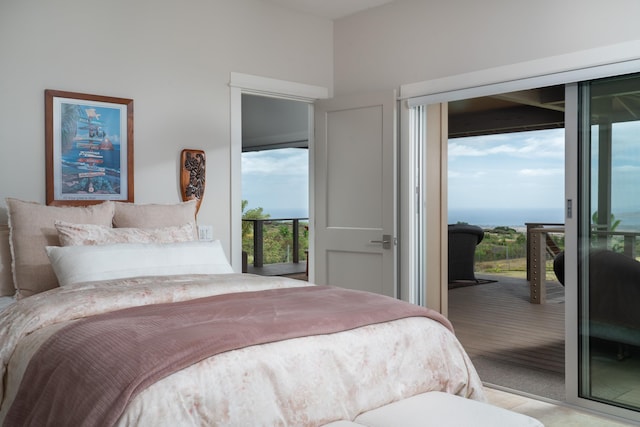 bedroom featuring multiple windows, light carpet, a water view, and access to exterior