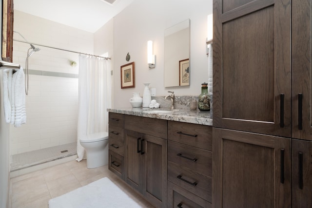 bathroom with a shower with curtain, vanity, toilet, and tile patterned floors