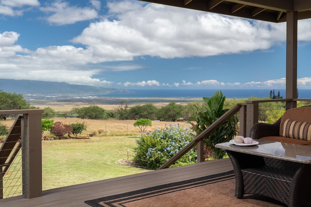 wooden balcony featuring a rural view and a deck