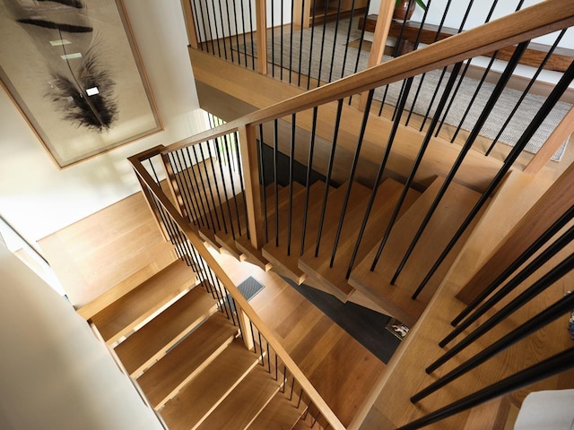 stairs with hardwood / wood-style floors