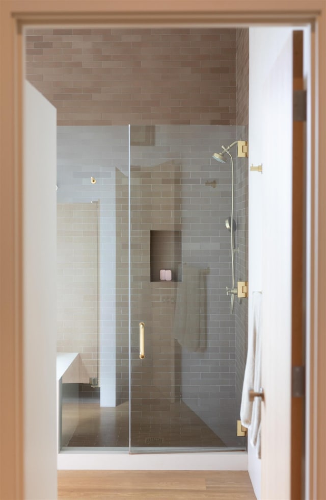 bathroom with a shower with door