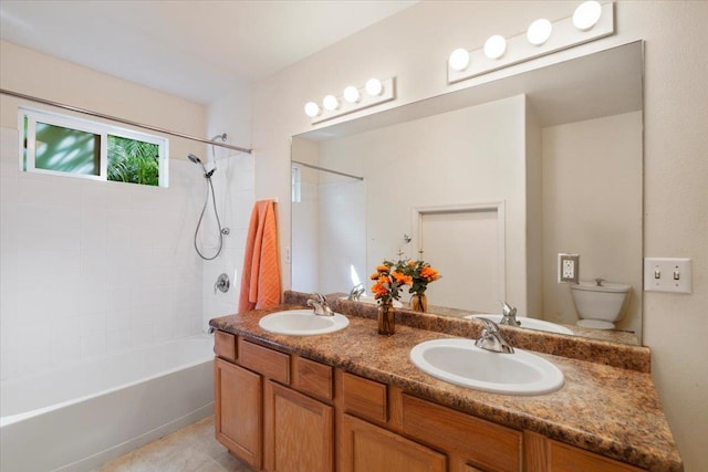 full bath featuring double vanity, toilet, tub / shower combination, and a sink