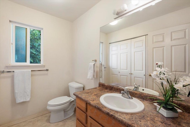 bathroom featuring baseboards, toilet, vanity, and tile patterned flooring