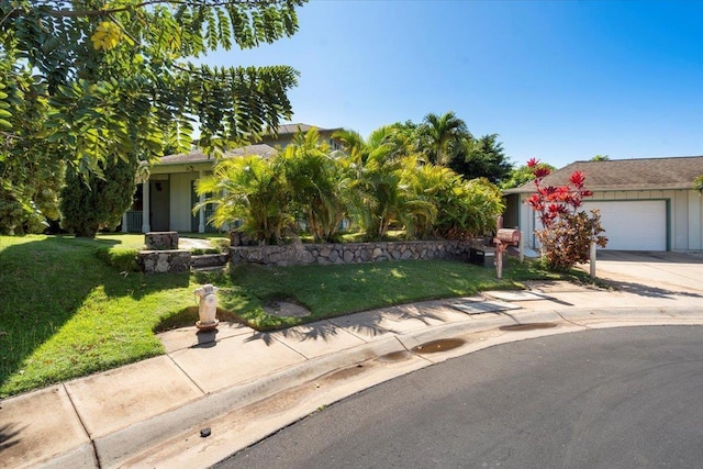 obstructed view of property featuring driveway, an attached garage, and a front lawn