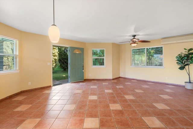 empty room with light tile patterned floors, baseboards, and ceiling fan