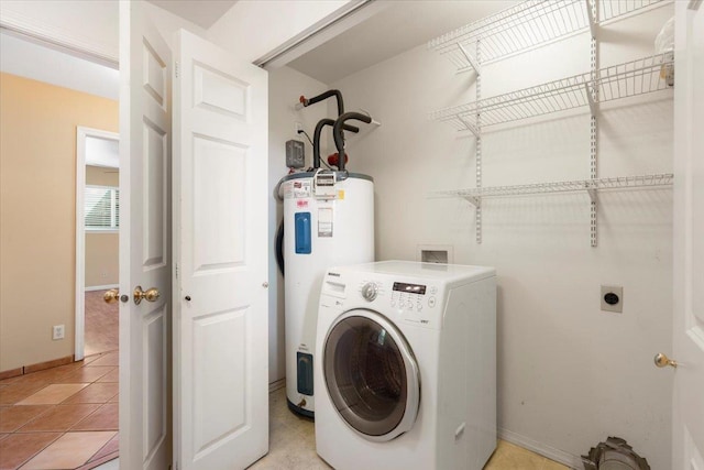 laundry room with washer / clothes dryer, electric water heater, light tile patterned floors, baseboards, and laundry area