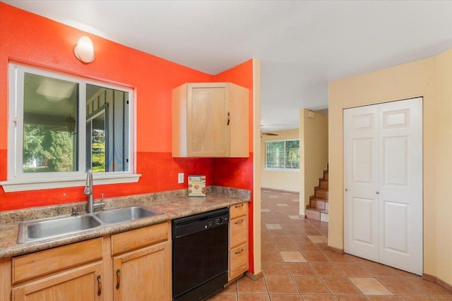 kitchen with a sink, black dishwasher, light tile patterned flooring, and light brown cabinetry