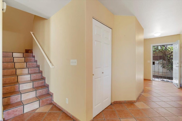 stairs with tile patterned flooring and baseboards