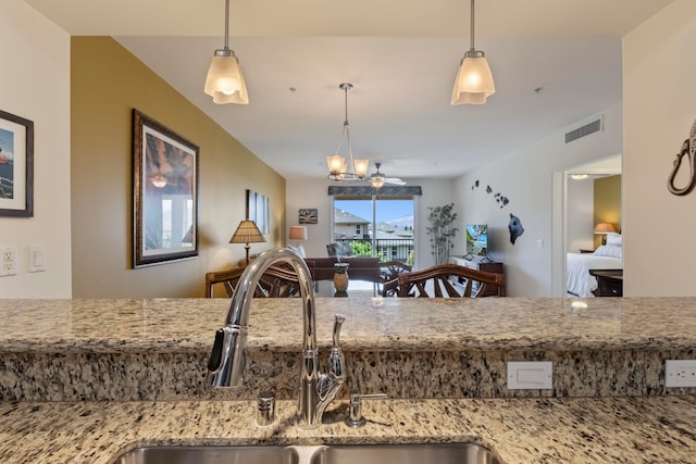 28 Hauwahine Ln Unit F203, Kihei, HI 96753 - kitchen with open floor plan, light stone countertops, and pendant lighting