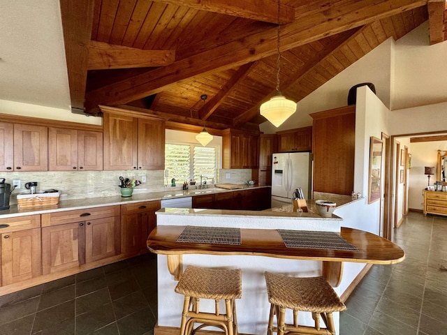 kitchen with white fridge with ice dispenser, wooden ceiling, light countertops, pendant lighting, and backsplash