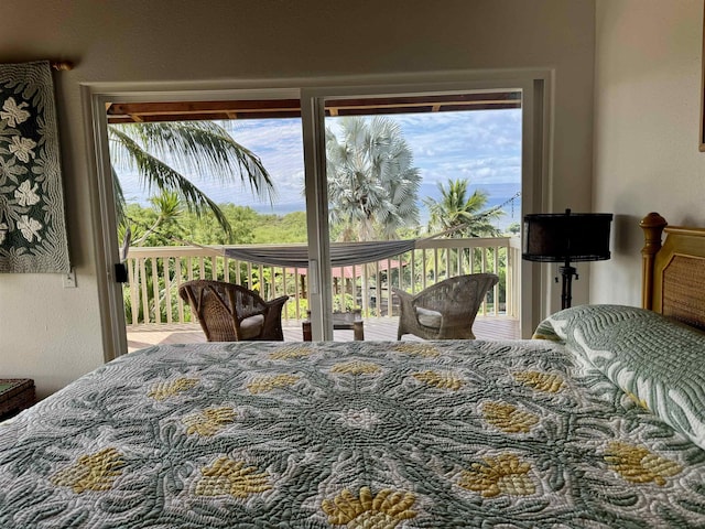 bedroom with access to outside and a textured wall