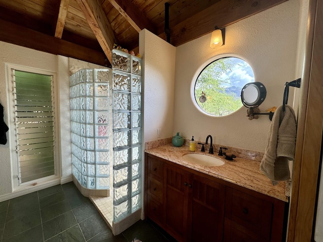 bathroom with wood ceiling, walk in shower, a textured wall, vanity, and tile patterned flooring