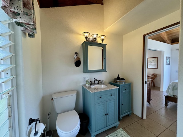 bathroom with tile patterned flooring, toilet, and vanity
