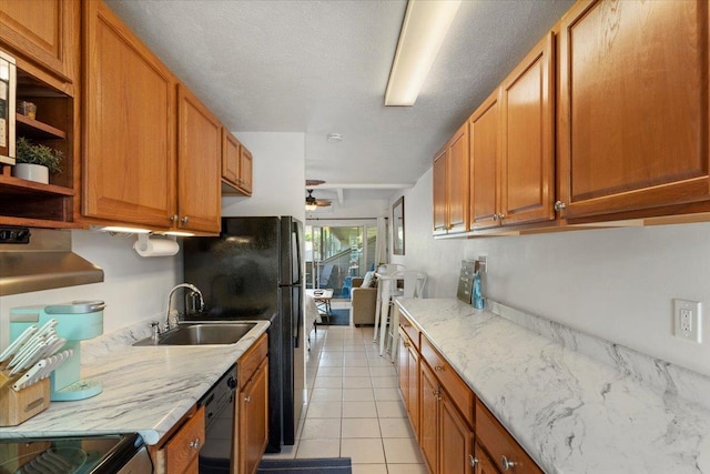 kitchen featuring light stone countertops, dishwasher, sink, ceiling fan, and light tile patterned floors