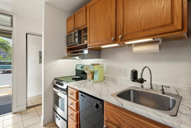 kitchen featuring sink, light tile patterned floors, black appliances, and range hood