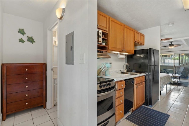 kitchen featuring black appliances, sink, light tile patterned flooring, ceiling fan, and electric panel