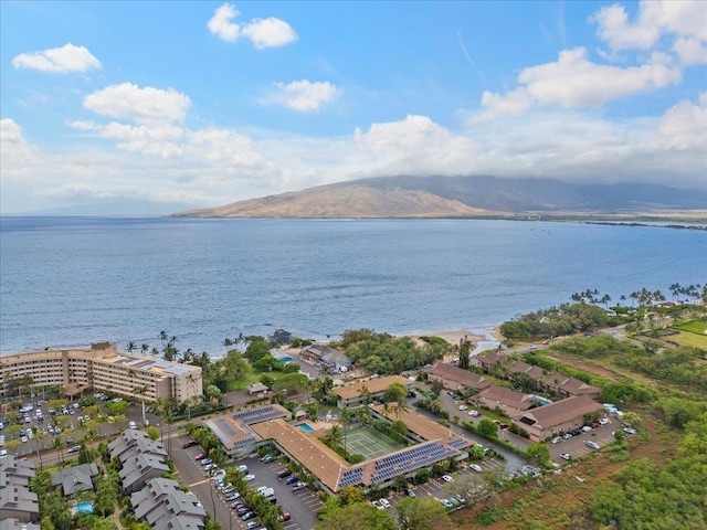 drone / aerial view featuring a water and mountain view