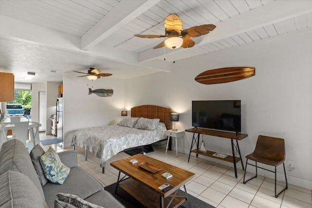 tiled bedroom with ceiling fan, beam ceiling, and stainless steel refrigerator