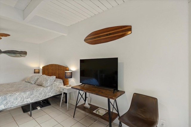 bedroom featuring beam ceiling and light tile patterned floors