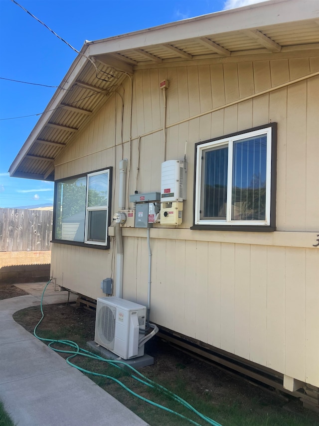 view of side of home featuring ac unit