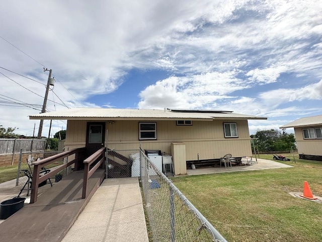 back of house with a yard and a patio area