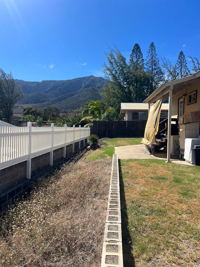 view of yard with a patio and a mountain view