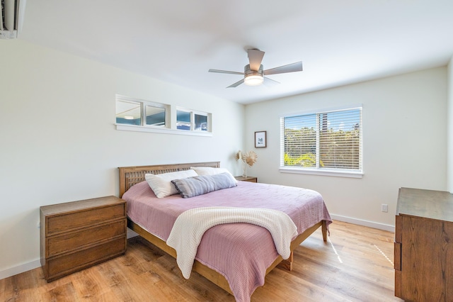 bedroom with ceiling fan and light hardwood / wood-style flooring