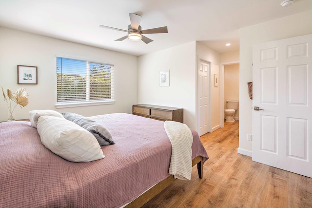 bedroom featuring ceiling fan, connected bathroom, and light hardwood / wood-style flooring