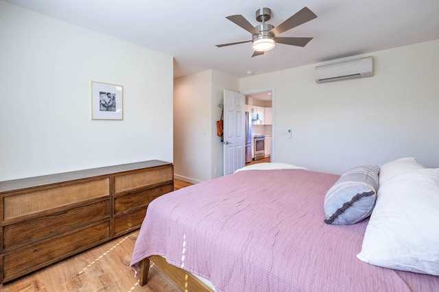 bedroom with stainless steel refrigerator, ceiling fan, a wall mounted air conditioner, and light hardwood / wood-style floors